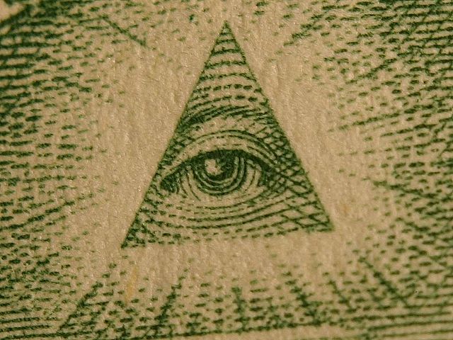 A photograph of the in a triangle on a U.S. dollar bill.