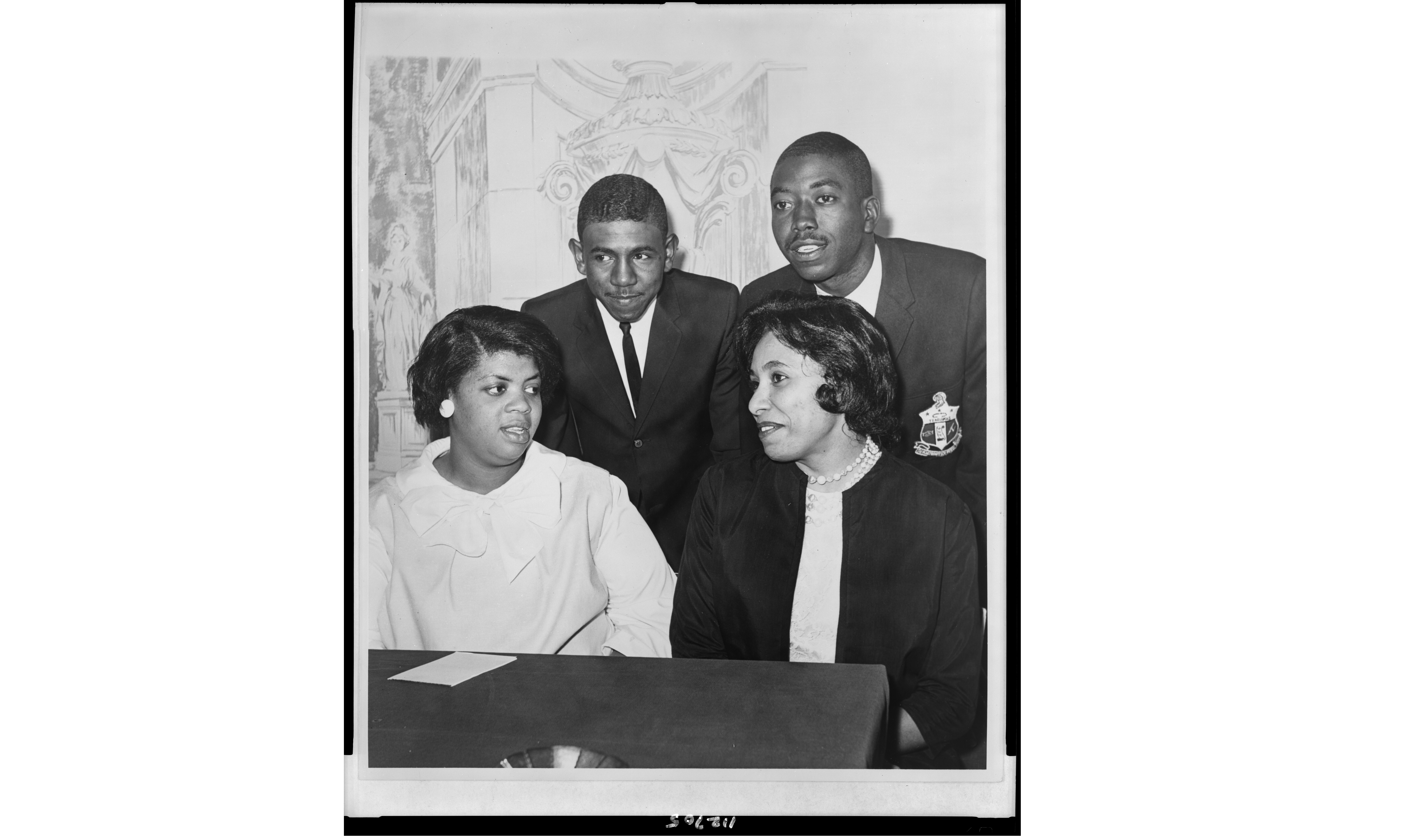 Historical b&w photo: Linda Brown Smith, Ethel Louise Belton Brown, Harry Briggs, Jr., and Spottswood Bolling, Jr. during press conference